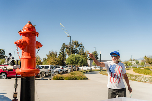Man playing the fire hydrant ring toss game at Waterpalooza.